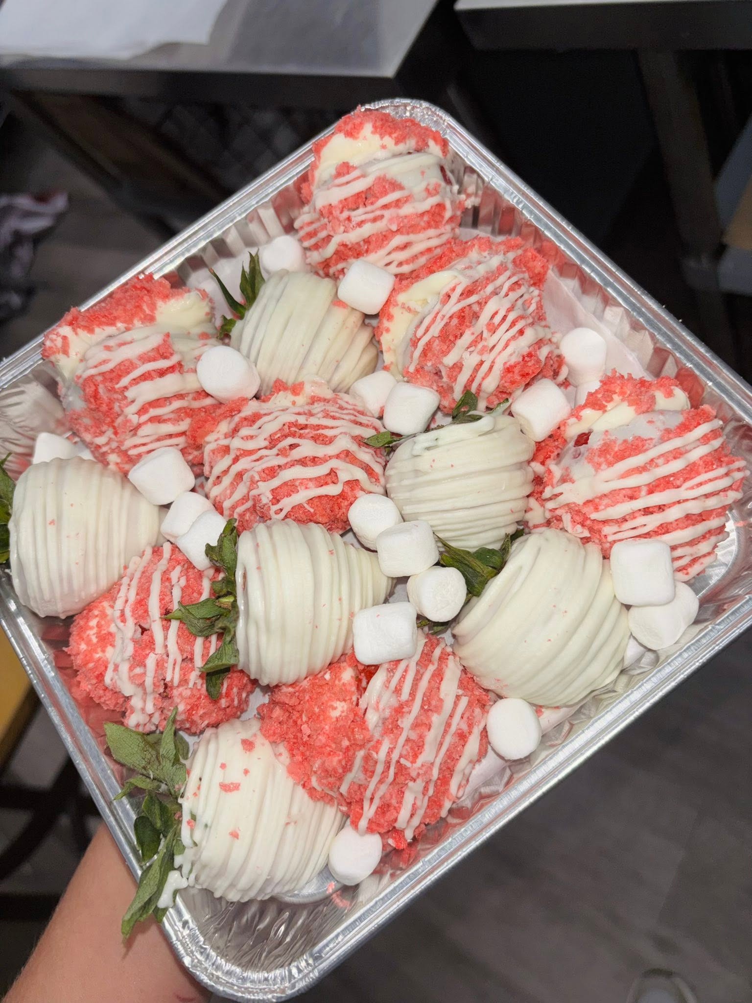 Assorted white chocolate and cheesecake stuffed strawberries with crumble